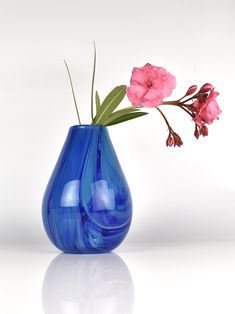 a blue vase with pink flowers in it