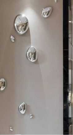 the wall is decorated with many different shapes and sizes, including round glass knobs