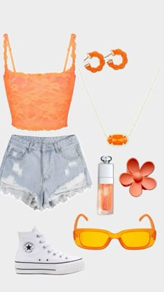 an orange top, shorts and sunglasses are arranged in the shape of a woman's outfit