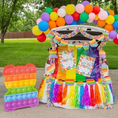 a car decorated with colorful balloons and decorations