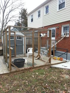 a backyard area with a fence, patio and hot tub in the middle of it