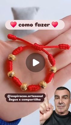 an image of a person holding a red string bracelet with gold beads and hearts on it