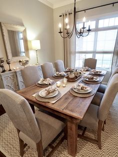 the dining room table is set with dishes and place settings for six people to eat