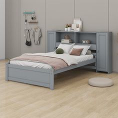 a bed sitting on top of a hard wood floor next to a wall mounted shelf