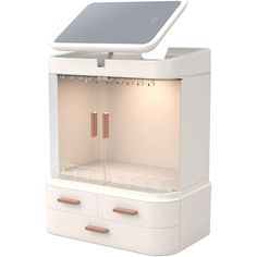 a white cabinet with two drawers and an electronic device on it's top shelf