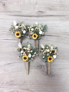 three vases filled with flowers on top of a wooden table