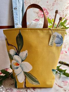 a yellow bag with flowers painted on it