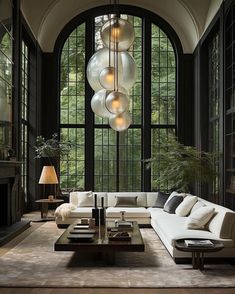 an elegant living room with large windows and lots of furniture in the middle of it