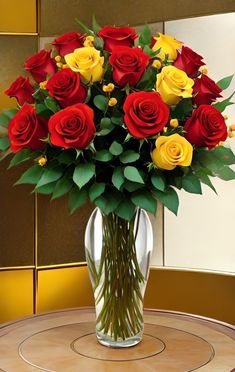 a vase filled with red and yellow roses