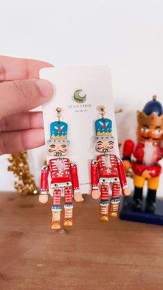 a pair of nutcrackers is being held up by a person's hand