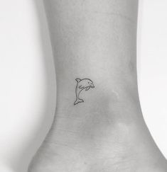 a small dolphin tattoo on the ankle