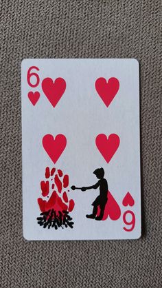 a playing card with hearts on it and a campfire in the middle is shown