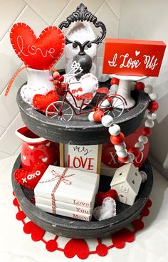 a three tiered tray with valentine's day decorations