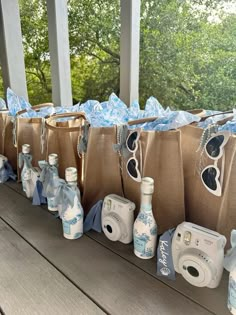 several bags with items on them sitting on a table near water bottles and other items