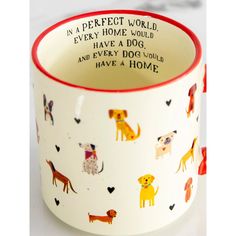 a coffee mug with dogs on it sitting on a table