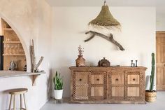 a living room filled with lots of furniture next to a wall mounted bird on the wall