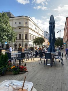 an outdoor dining area with tables and chairs