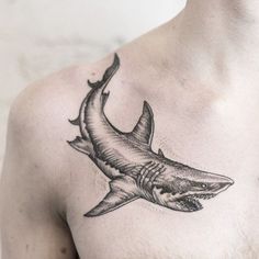 a man with a shark tattoo on his chest