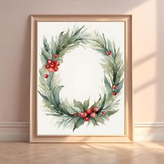 a watercolor painting of a christmas wreath with red berries and green leaves on it