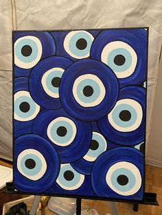 a painting with blue and black circles on it