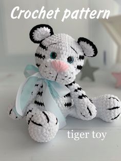 a crocheted tiger sitting on top of a white table next to a star