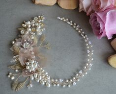 a headband with pearls and flowers on it