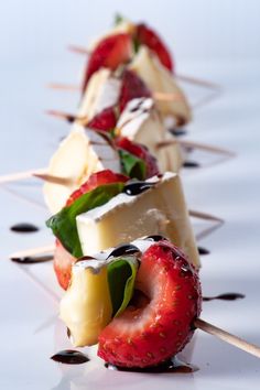 strawberries and cheese skewers on toothpicks with chocolate drizzle