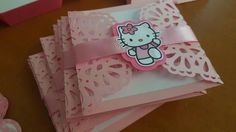 a hello kitty card on top of pink doily