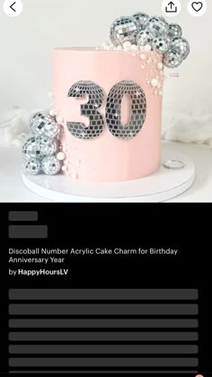 a pink cake with the number 30 on it and some silver balls in front of it