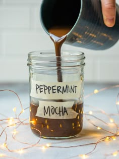 someone pouring peppermin mocha into a jar