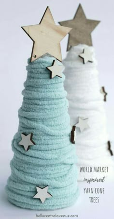 two small trees made out of yarn with stars on top and the words world market imperfected yarn cone trees