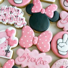 some decorated cookies with minnie mouse and mickey mouse on them for a 1st birthday party