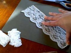 someone is cutting out lace on a piece of paper that has been cut into smaller pieces