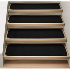 a set of stairs with black carpet on them