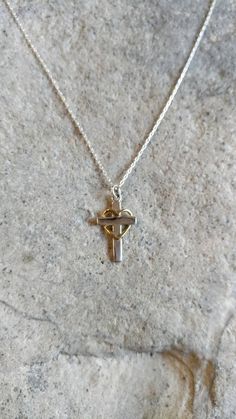 "Tiny sterling cross with gold heart necklace. The Sterling silver cross charm is a dainty 12 mm across and 20 mm tall with a shiny finish. It has a delicate gold fill heart wrapped around it and hangs from a Sterling Silver chain. Shown here in 17\" length. *If you are unsure of the length you need, or would like to wear this item at different lengths, we now offer an adjustable length option! You can add an adjustable end to your necklace using this link: https://www.etsy.com/listing/791277751 Cross With Heart, Cross Necklace Gold, Silver Cross Necklace, Sterling Silver Cross Necklace, Silver Cross Pendant, Gold Cross Necklace, Gold Heart Necklace, Solid Gold Jewelry, Sterling Silver Cross