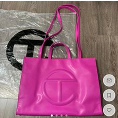 Large Telfar Bag W/ Zipper Pouch Inside - Vegan Leather - Comes W/ Dust Bag & Plastic Bag Color: Hot Pink/ Azalea Condition: Good; Small Wear Marks On Bottom Corners Of Bag (Can Use Angelus Leather Paint) Size: Height 14 3/4", Width 19 1/4", Depth 7", Strap Drop 21", Handle Drop 5 1/2" *Bag Is Sanitized Before Shipping* Designer Pink Box Bag With Large Capacity, Tan Bags With Detachable Handle, Tan Bag With Detachable Handle, Tan Bags With Dust Bag For On-the-go, Tan Bags With Detachable Handle For Shopping, Tan Shopping Bag With Detachable Handle, Tan Shopping Bags With Double Handle, Tan Pouch Bag With Removable Pouch, Trendy Tan Bags With Detachable Handle