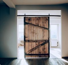 an open wooden door in the middle of a room