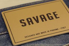 a tag that says savge on it sitting in the back pocket of a pair of jeans