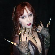 a woman with red hair and nails on her hands