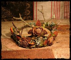 Custom order--a full size magical crown sturdy enough to wear or for display. A perfect accessory for festivals, weddings or costume parties. Made of vine, twigs, cedar rosettes, horse chestnut hulls, lichen, and moss. Approximately 17 centimeters across. If the crown is to be worn, please include a note with the wearer's head measurement above the eyebrows to facilitate a better fit. Custom crowns are available to order--please see other photos and my other listings if you would like something Halloween Couture, Dryad Costume, Fantasy Crowns, Twig Crown, Tree Goddess, Fae Costume, Witch Crown, Mermaid Crowns, Forest Witch