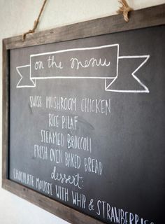 a chalkboard sign hanging on the wall with some writing on it that says on the menu