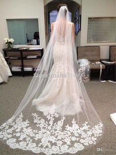 a wedding veil with white flowers on it