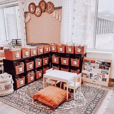 a room filled with lots of boxes on the floor next to a table and chair