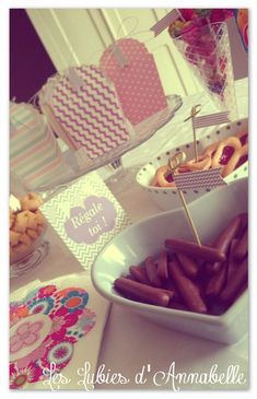 a table topped with lots of different types of food next to plates and napkins