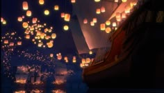 many paper lanterns floating in the air over water with boats and sailboats on it