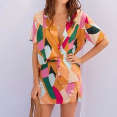 Stand out in style with this unique colorful button up blouse. Rayon Imported Orange V-neck Shirt For Summer, Orange V-neck Summer Shirt, Casual Button-up Top With Vibrant Print, Multicolor V-neck Shirt With Button Closure, Multicolor V-neck Shirt For Summer, Colorful V-neck Blouse For Vacation, Vibrant V-neck Blouse For Day Out, Retro V-neck Summer Blouse, Summer Multicolor Shirt With Vibrant Print