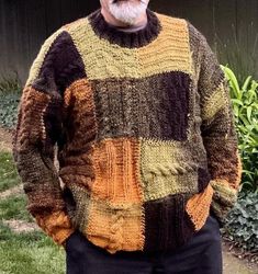 an older man wearing a multicolored sweater