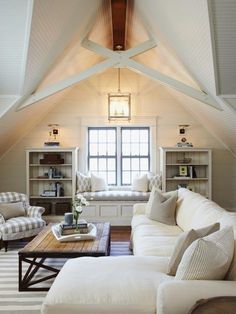 a living room filled with furniture and a large window