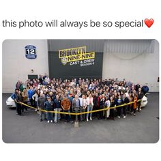 a group of people standing next to each other in front of a building with the words brooklyn nine - nine on it