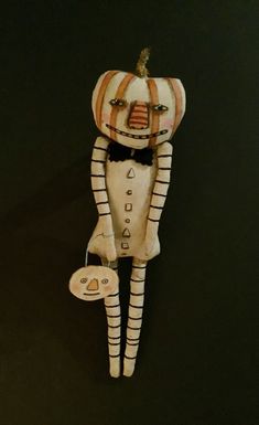 a white and orange striped doll with black hair